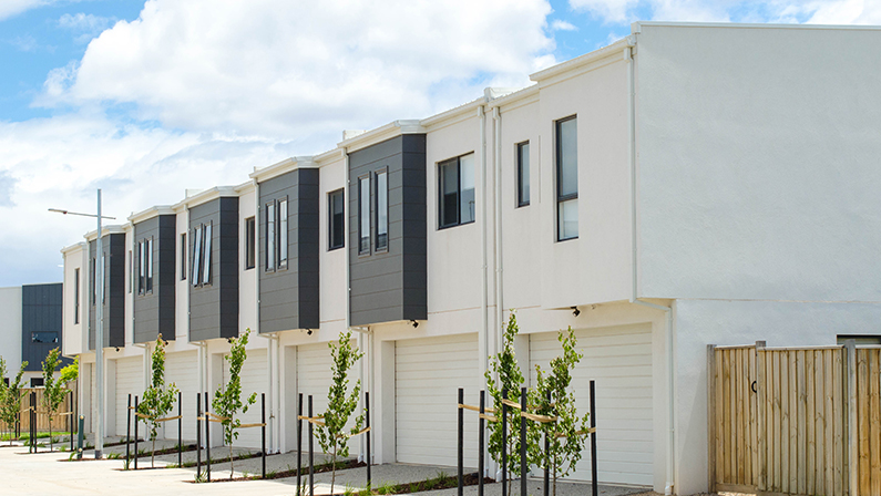 A row of residential townhomes or townhouses in Melbourne's suburb, VIC Australia. Concept of real estate development, the housing market, and homeownership.