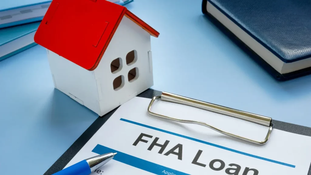 FHA loan application and a model of home.