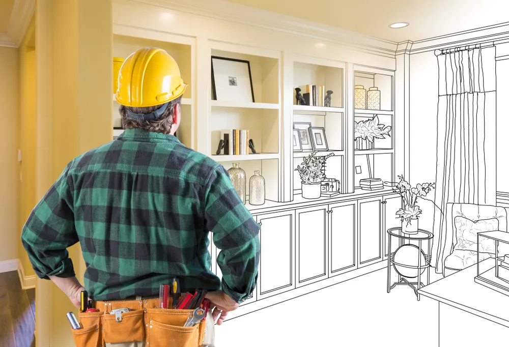 Contractor assessing custom built-in shelving plans as part of the best ROI home improvements in Houston.