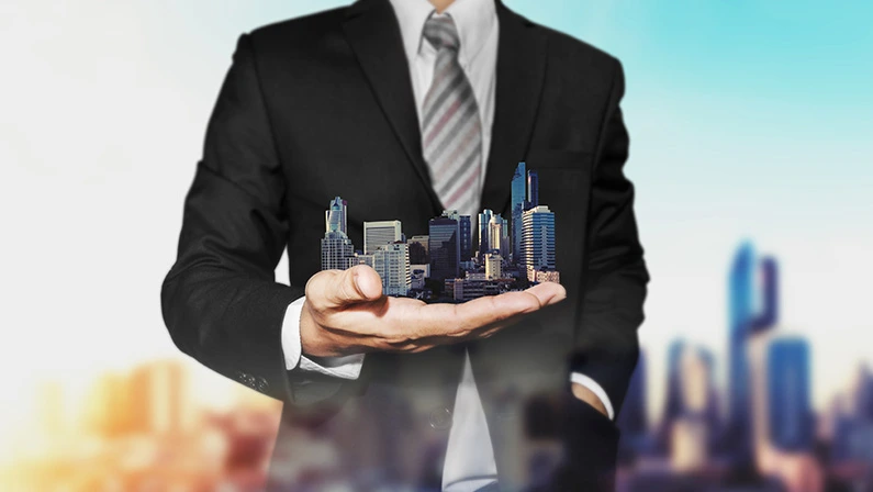 Real estate property concept, Business real estate agent holding modern buildings on hand