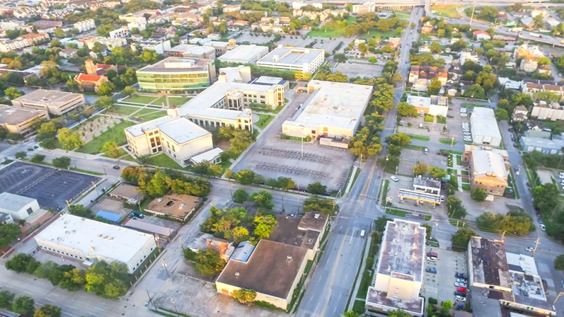 Aerial view business management district in midtown Houston, Texas, US. Office buildings, restaurants, parking lots, church bordered by Neartown, Interstate 69, Highway 59, I-45 southwest of Downtown